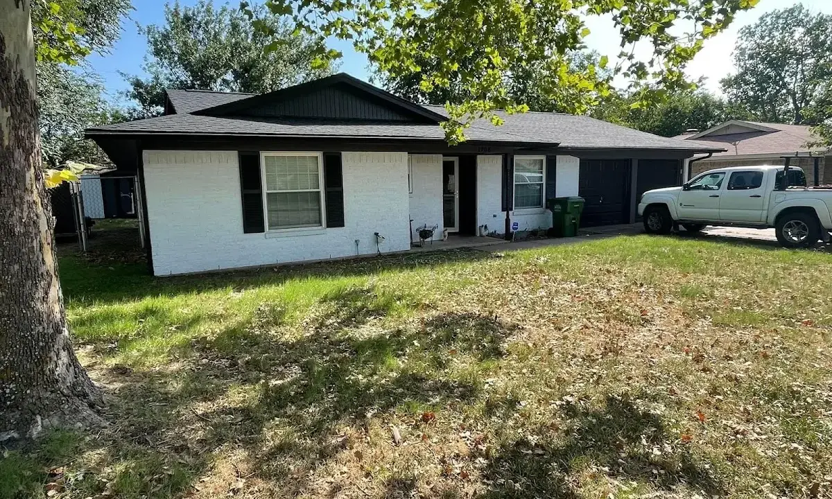 Professional roofing crew working on a residential roof in San Angelo